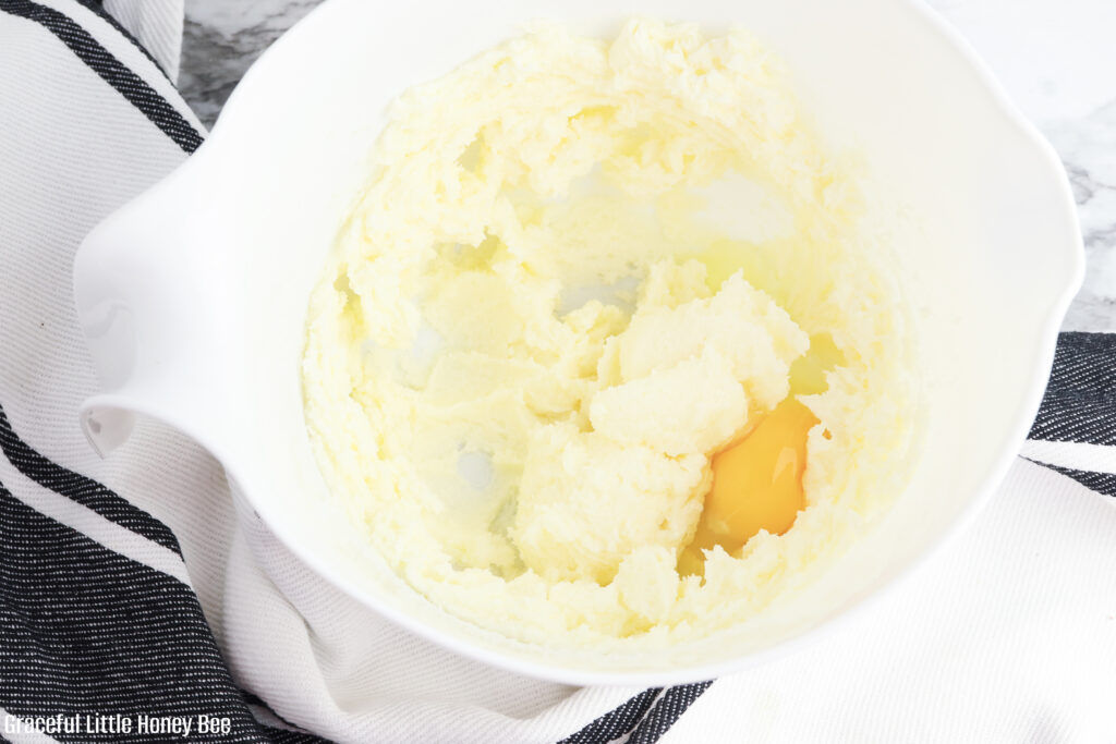 Sugar, butter and eggs in a mixing bowl.
