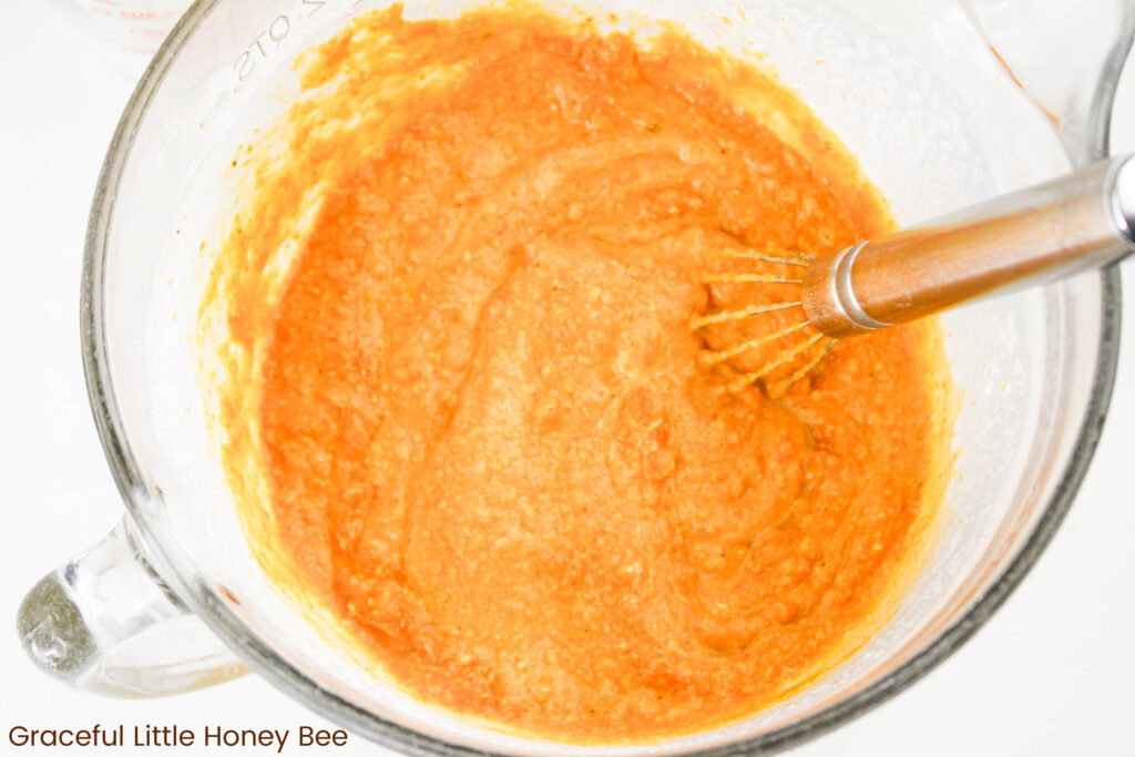 Pumpkin mixture in a clear mixing bowl.