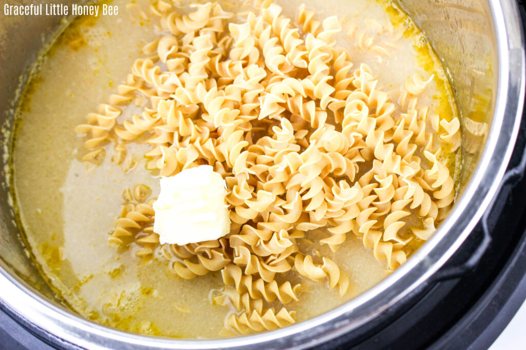 Uncooked noodles in chicken broth.