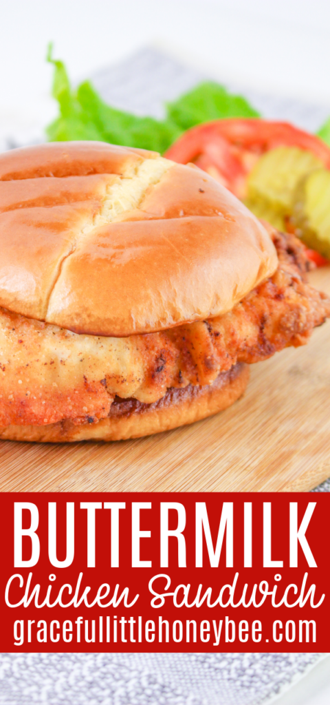 Buttermilk fried chicken sandwich sitting on a cutting board.