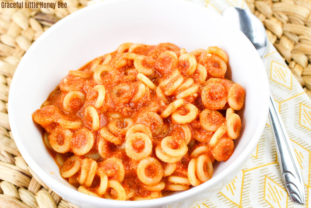 Close up view of Spahgettios in a round white bowl.