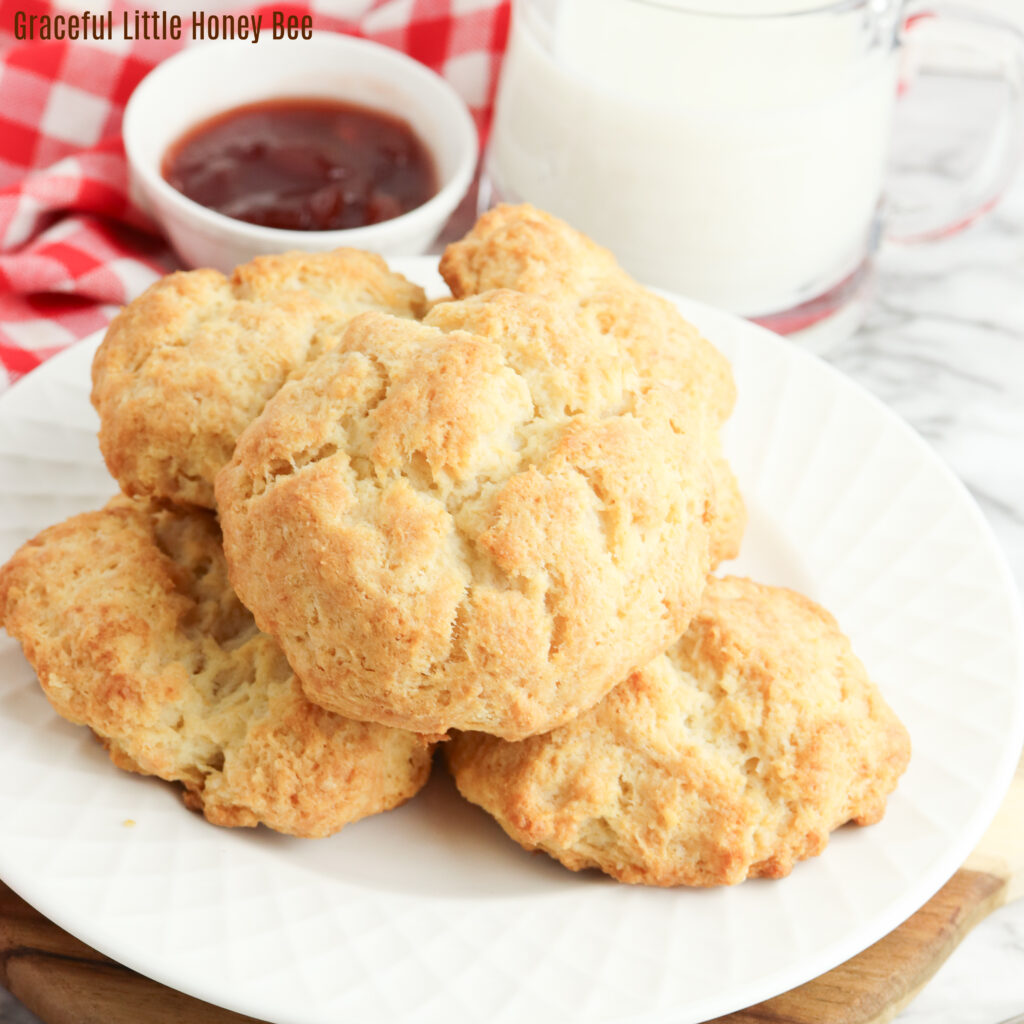 Aerial view of sour cream biscuits sitting on a plate.