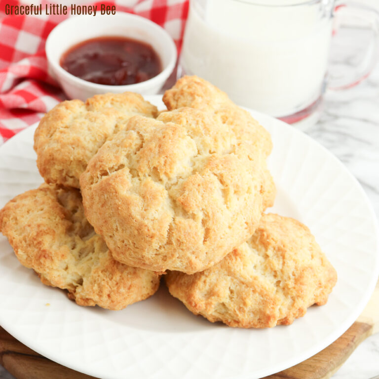 Aerial view of sour cream biscuits sitting on a plate.