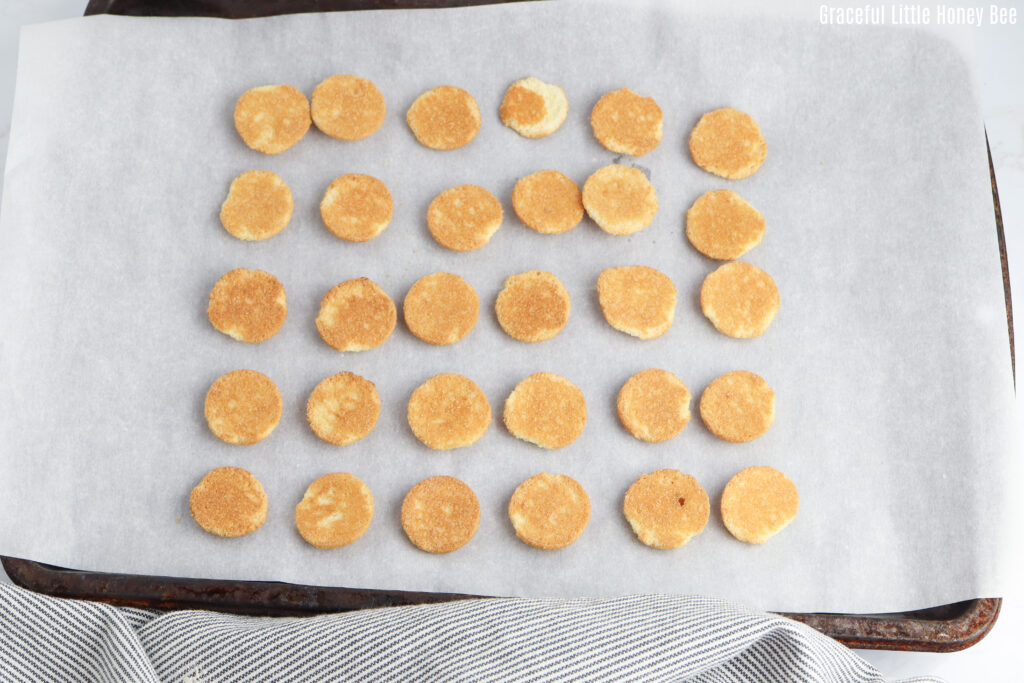 Nilla Wafers laid out in neat rows on a baking sheet.