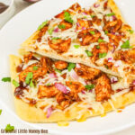 Slices of BBQ Chicken Flatbread pizza on a plate.