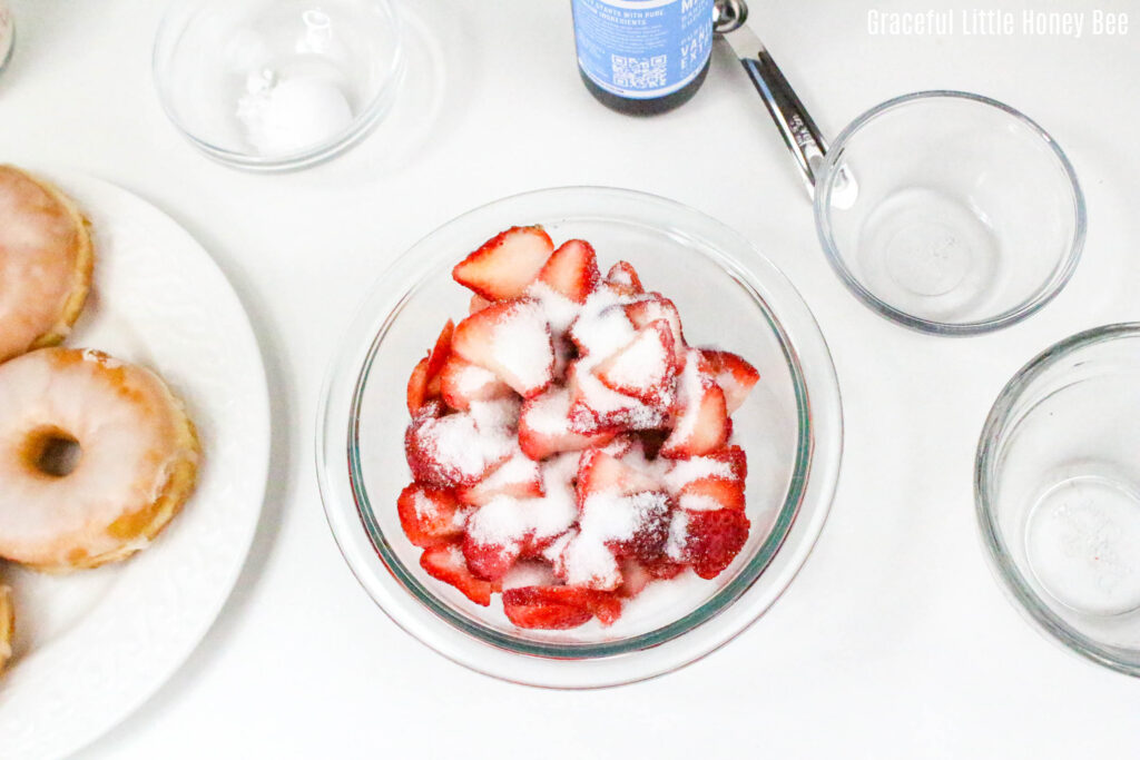 Sliced strawberries topped with sugar.