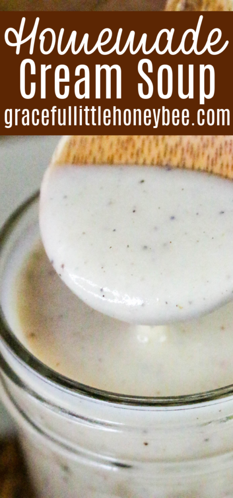 Cream of chicken soup in a mason jar being scooped out by a wooden spoon.