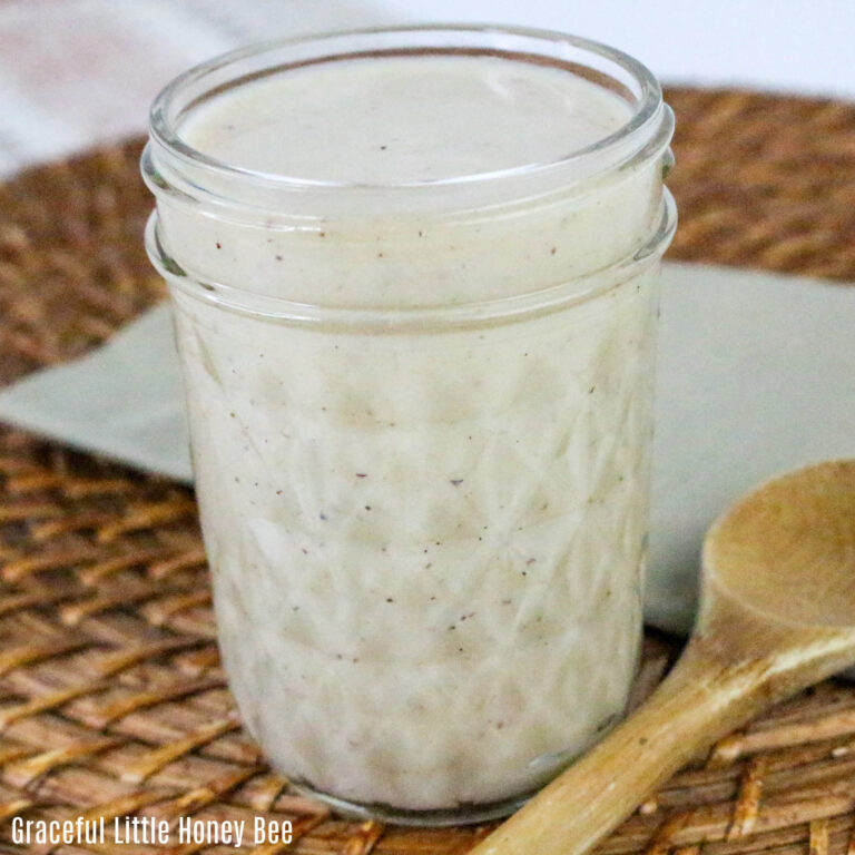 Cream of chicken soup in a mason jar being scooped out by a wooden spoon.