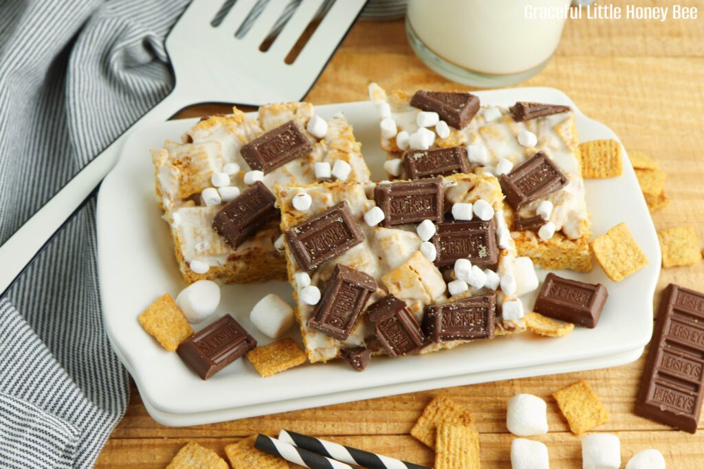 S'mores bars sitting on a square white plate.