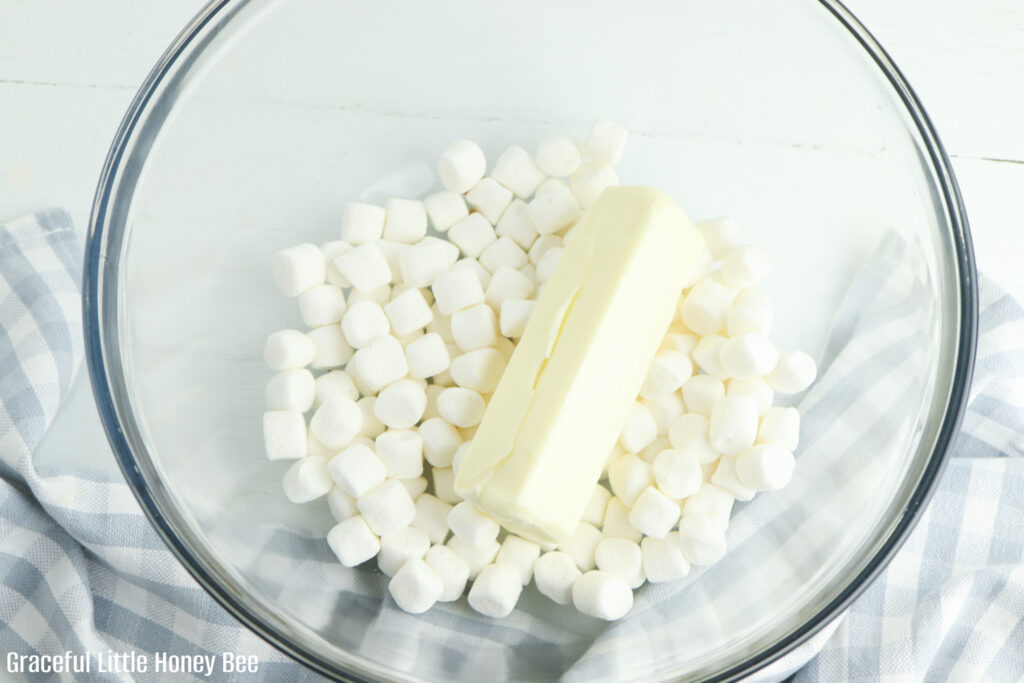 Mini marshmallows and butter in a mixing bowl.