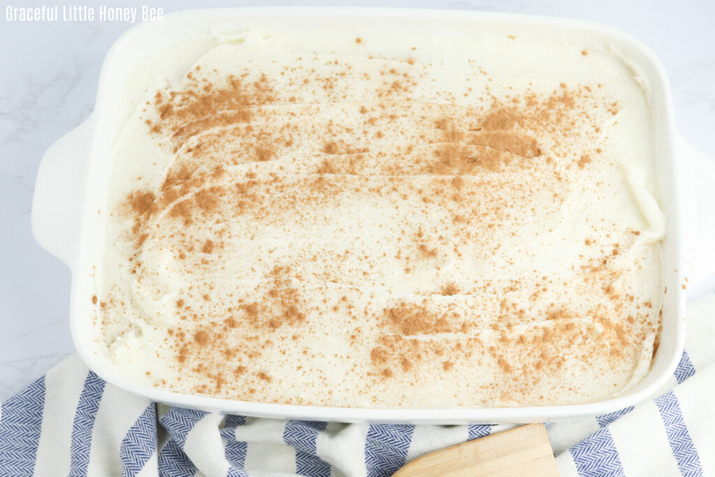 Cinnamon roll poke cake in a cake pan.