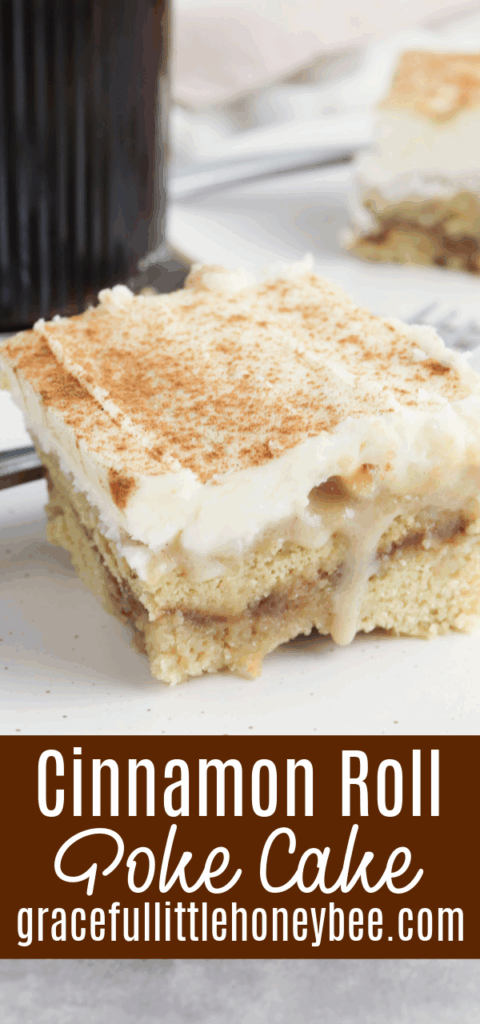 Close up view of cinnamon roll poke cake on a white plate.