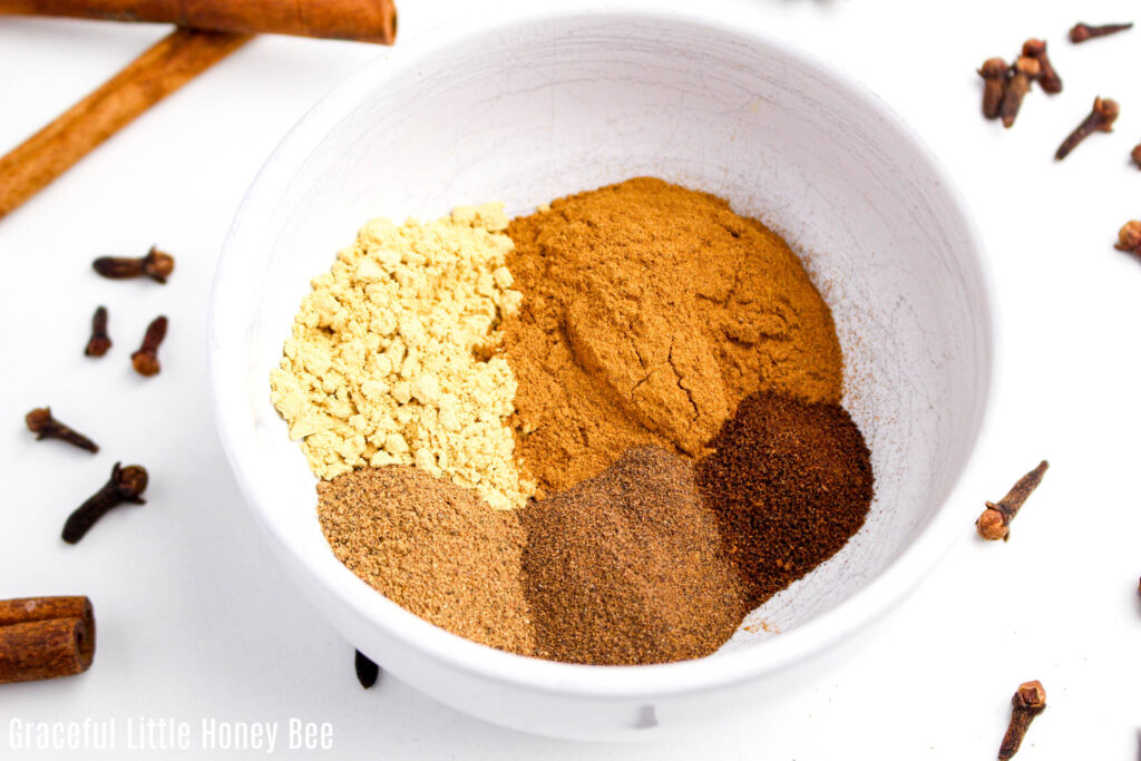 Spices in white bowl before being mixed together.