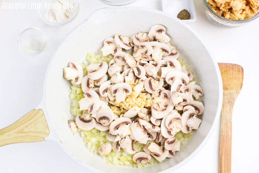 Fresh onion, garlic and mushrooms in pan.