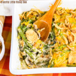 Aerial view of green bean casserole with a wooden spoon resting on the side of the dish.