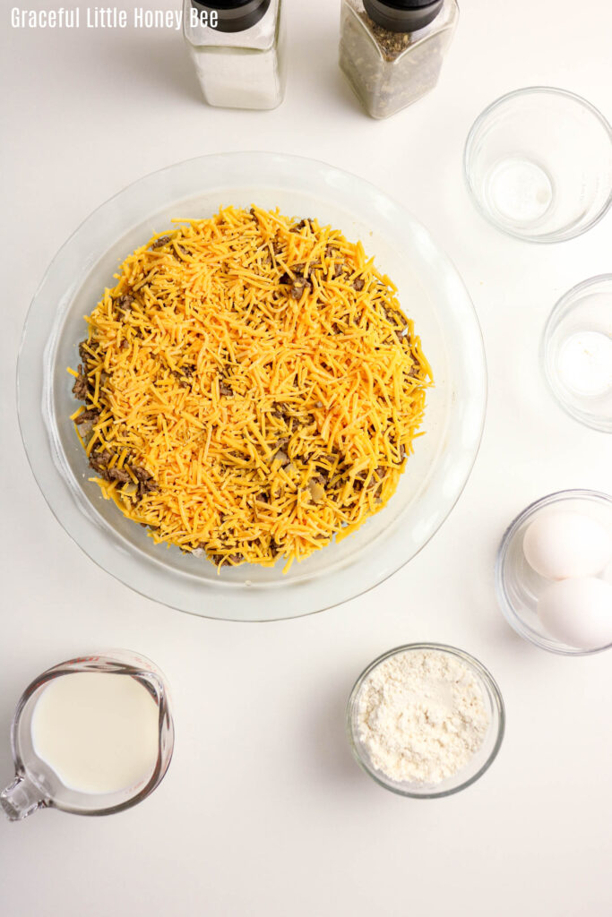 Aerial view of beef and cheese in glass pie dish.