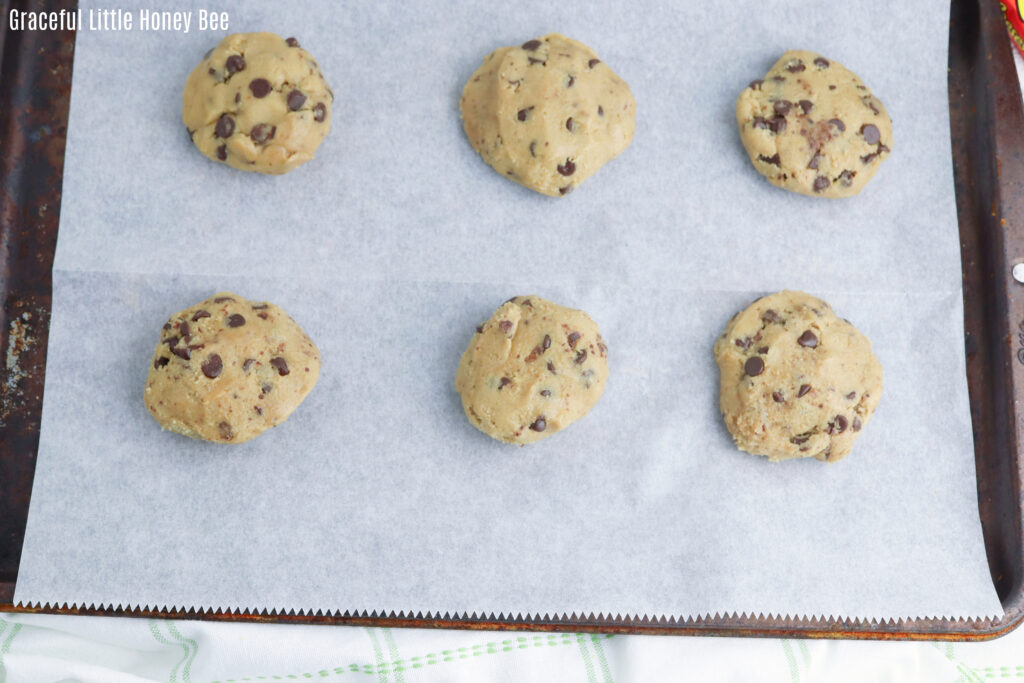 Reese's stuffed cookie dough on a baking sheet.