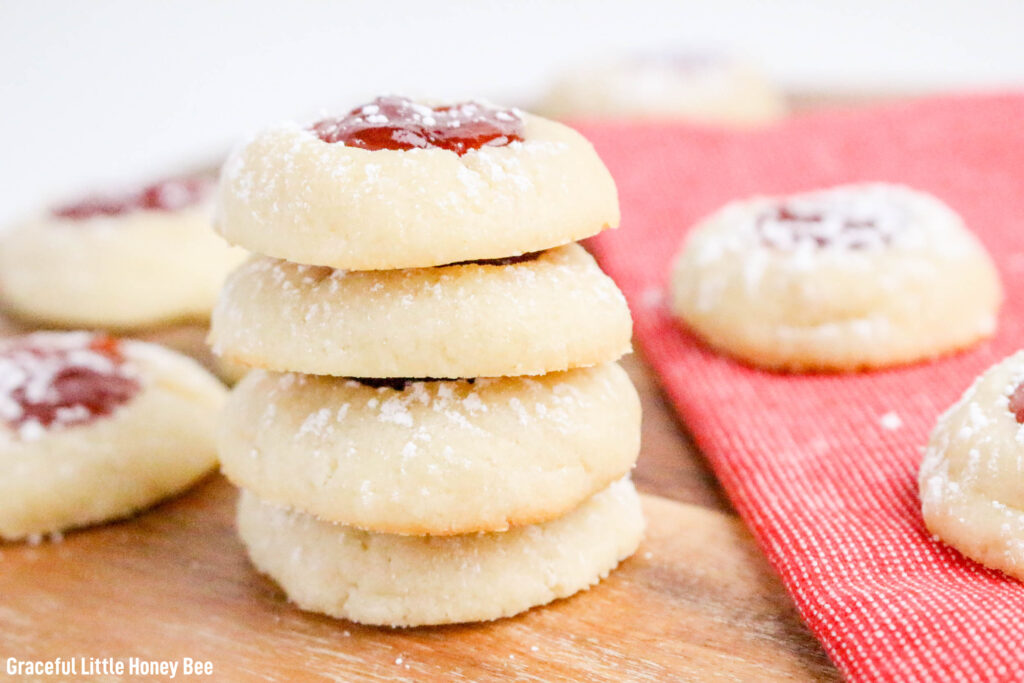 A stack of cream cheese thumbprints on a cutting board.