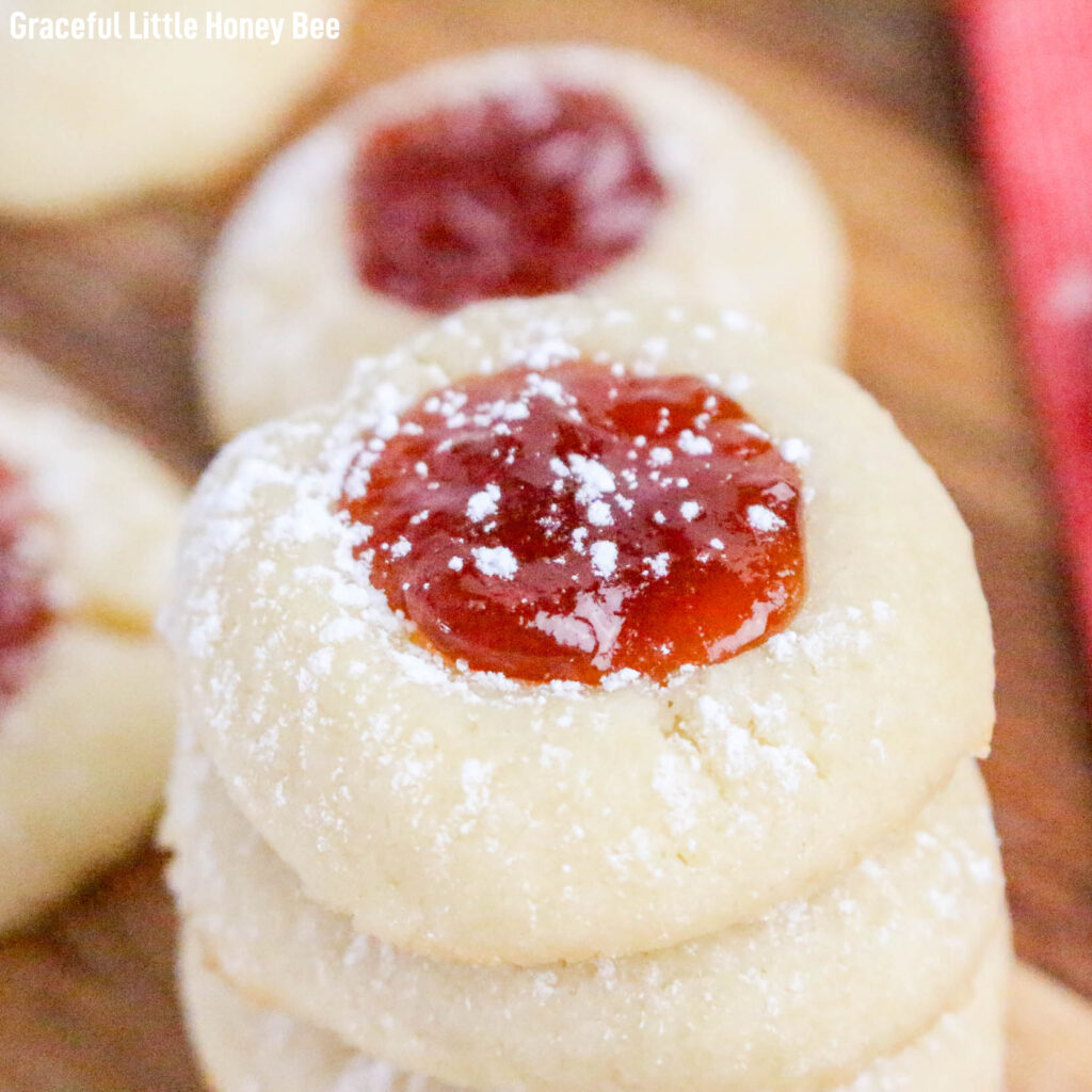 A stack of cream cheese thumbprints on a cutting board.