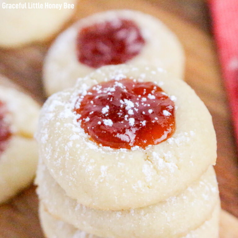 A stack of cream cheese thumbprints on a cutting board.