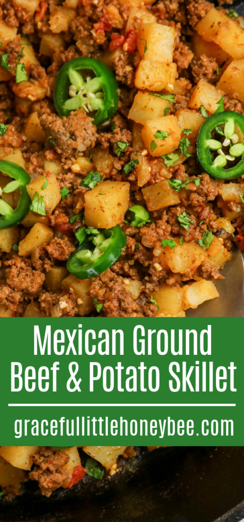 Ground beef and potatoes topped with fresh slices of jalapenos in a skillet.