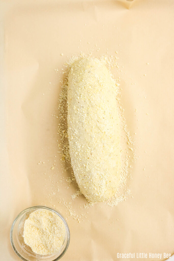 Bread dough sprinkled with Parmesan cheese.