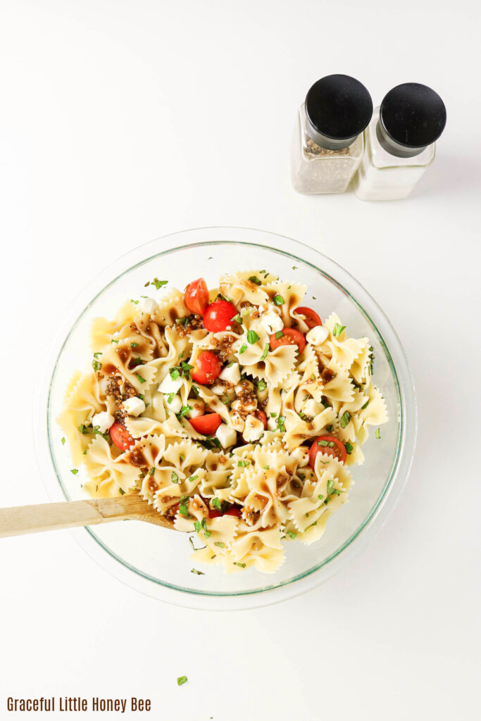 Caprese Pasta Salad in a glass mixing bowl.