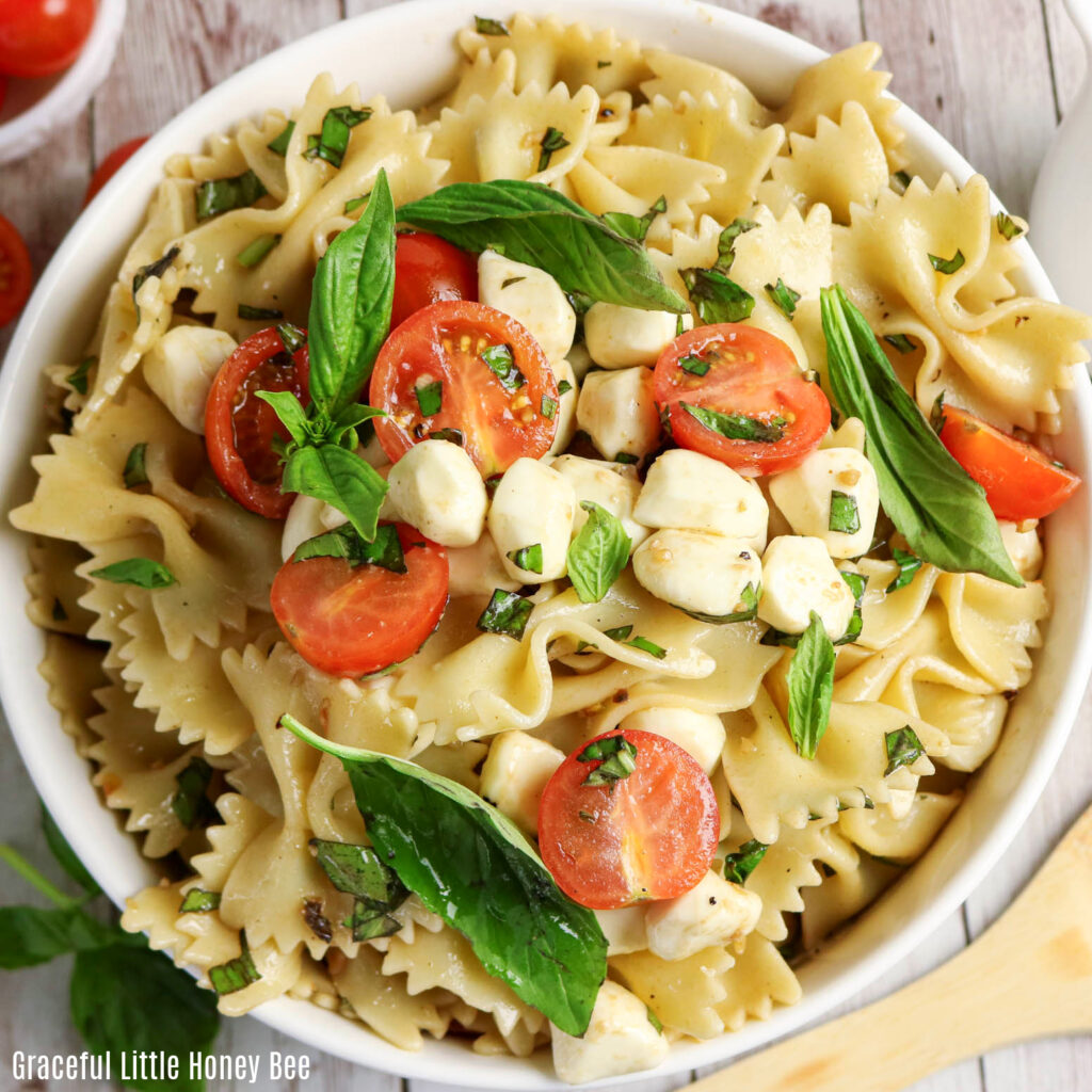 Close up view of Caprese Pasta Salad garnished with basil.
